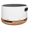 A white tabletop grill with a black handle and a cork base, shown against a white background. Produktbild-Vorschau