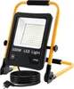 A 100W LED work light with a yellow stand and black housing, shown with its power cord coiled at the base. Produktbild-Vorschau