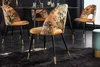 A dining room scene with four chairs around a table, featuring a floral pattern and gold accents. Produktbild-Vorschau