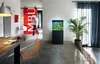 A modern living room with an aquarium, dining table, and a person walking in the background. Podgląd zdjęcia produktu