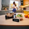A kitchen scene with a woman preparing food, a pot on a stove, a bowl of salad, and a digital clock. Anteprima dell’immagine prodotto