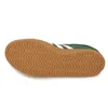 The underside of a green Adidas sneaker with a brown gum sole. Produktbild-Vorschau