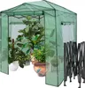 A green greenhouse filled with various potted plants, with a folded metal frame to the right. Náhled obrázku produktu