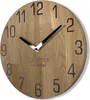 A close-up view of a wooden wall clock with black numbers and hands. Náhled obrázku produktu