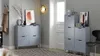 Two hallway storage cabinets with doors, a chair, and wall art in a modern entryway. Náhled obrázku produktu
