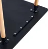 Close-up view of the underside of a black table with wooden legs attached. Voir les images du produit