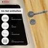 A door handle set and its components are displayed on a wooden door. Produktbild-Vorschau