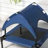 A close-up view of a blue elevated dog bed with a canopy. Náhľad obrázku produktu