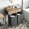 A laundry cart with two baskets and two drawers is placed in a bathroom next to a bathtub. Voir les images du produit