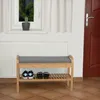 A shoe rack with a seat and shoes on the lower shelf, placed in a hallway near a window and a door. Produktbild-Vorschau