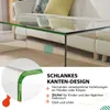 A close-up view of a glass coffee table with green accents, placed in a living room setting next to a sofa. Voir les images du produit