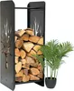A black metal firewood rack filled with logs, next to a potted plant. Voir les images du produit