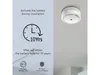 A smoke detector is mounted on a white ceiling, with marketing text and icons on the left side of the image. Produktbild-Vorschau