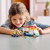 A young girl is playing with a LEGO ice cream truck toy set. Náhled obrázku produktu