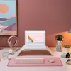 A desk setup with a laptop, keyboard, mouse, headphones, and decorative items. Produktbild-Vorschau