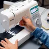 A person is using a Brother sewing machine to sew dark fabric. Produktbild-Vorschau