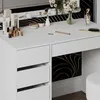 A white vanity table with drawers and makeup products on top. Produktbild-Vorschau