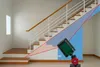 A laser measuring device is shown in front of a staircase, with projected laser lines indicating measurements. Produktbild-Vorschau