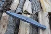A dark gray, curved object rests on a pile of chopped firewood. Náhled obrázku produktu