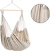 A beige fabric hammock chair hanging from a wooden bar. Náhled obrázku produktu