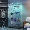 A display cabinet filled with various action figures and models, illuminated by LED lights, situated in a room next to a sofa. Náhled obrázku produktu