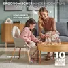 A mother and daughter are playing with blocks at a round wooden table, with the daughter sitting in a high chair. Produktbild-Vorschau