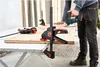 A person is using a jigsaw to cut a piece of wood that is clamped to a table with BESSEY clamps. Náhľad obrázku produktu