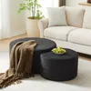 Two round ottomans are placed in a living room setting, with a couch and plant in the background. Produktbild-Vorschau