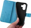 A hand holding a blue flip phone case with a floral and butterfly embossed design. Produktbild-Vorschau