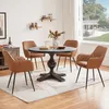 A dining set with four chairs and a round table in a room. Produktbild-Vorschau