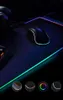 A gaming mousepad with RGB lighting and a mouse on it, with smaller circular images showing different lighting effects at the bottom. Produktbild-Vorschau