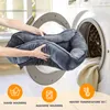 A person is placing a dog bed into a washing machine, with icons indicating washing instructions below. Produktbild-Vorschau