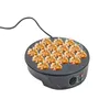 A takoyaki maker filled with takoyaki balls. Náhled obrázku produktu