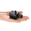 A hand holding a small black water pump. Produktbild-Vorschau