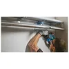 A person is using a cordless reciprocating saw to cut a pipe mounted on a wall. Anteprima dell’immagine prodotto