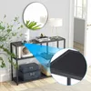 A black console table with items on it, placed in a room with a mirror and a plant. Podgląd zdjęcia produktu