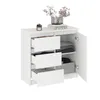 A white KOMTO Kommode with three drawers and a door, shown against a white background. Decorative items are placed on top. Produktbild-Vorschau