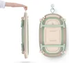 A person is holding a folded baby bathtub by its handle, and another view shows the bathtub hanging from a hook. Náhled obrázku produktu