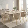 A dining room set with a marble-top table and six upholstered chairs. Anteprima dell’immagine prodotto