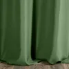 A close-up view of a green curtain hanging over a wooden floor. Anteprima dell’immagine prodotto