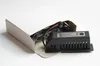 A black electronic component with wires is partially inside a white cardboard box. Náhled obrázku produktu