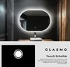 A modern bathroom with a lit mirror and sink. Produktbild-Vorschau