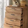 A close-up view of a wooden chest of drawers with five drawers, set against a window with sheer curtains. Náhled obrázku produktu