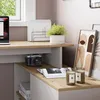 A desk setup with a laptop, camera, books, and decorative items. Anteprima dell’immagine prodotto