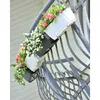 Flower boxes attached to a balcony railing. Produktbild-Vorschau