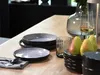 A table setting with plates, cutlery, pears, and a glass of wine. Náhľad obrázku produktu