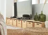A living room setting with a TV stand, television, and decorative vases. Voir les images du produit