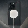A black leather iPhone case with red stitching is shown, with a white MagSafe charger attached. Produktbild-Vorschau