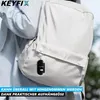 A person wearing a backpack with a KEYFIX keychain attached. Produktbild-Vorschau
