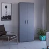 A room with a wardrobe, chair, and plant. Produktbild-Vorschau